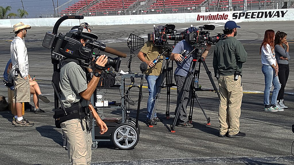 Film crew working on production set with lighting equipment