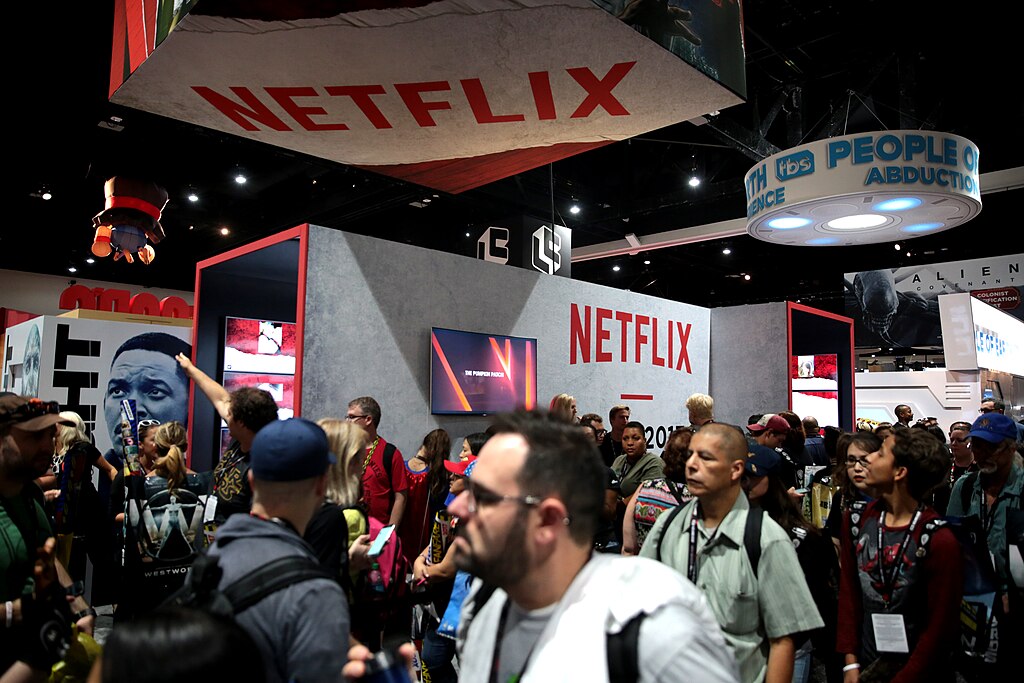 Netflix booth at convention with red branding and crowds