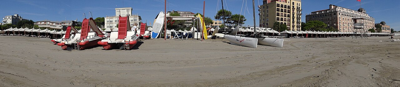 Mediterranean beach on the Lido island in Venice, Italy, with Hotel Excelsior in the background