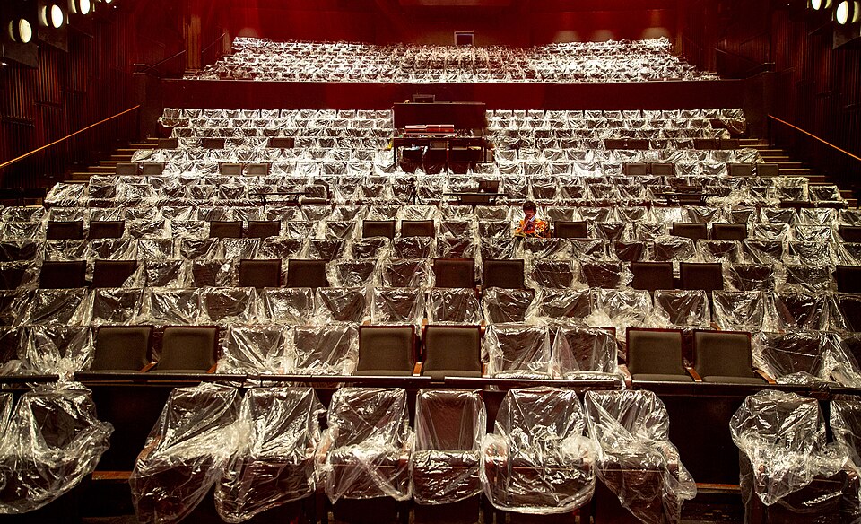 Interior of a theater with rows of empty seats awaiting an audience