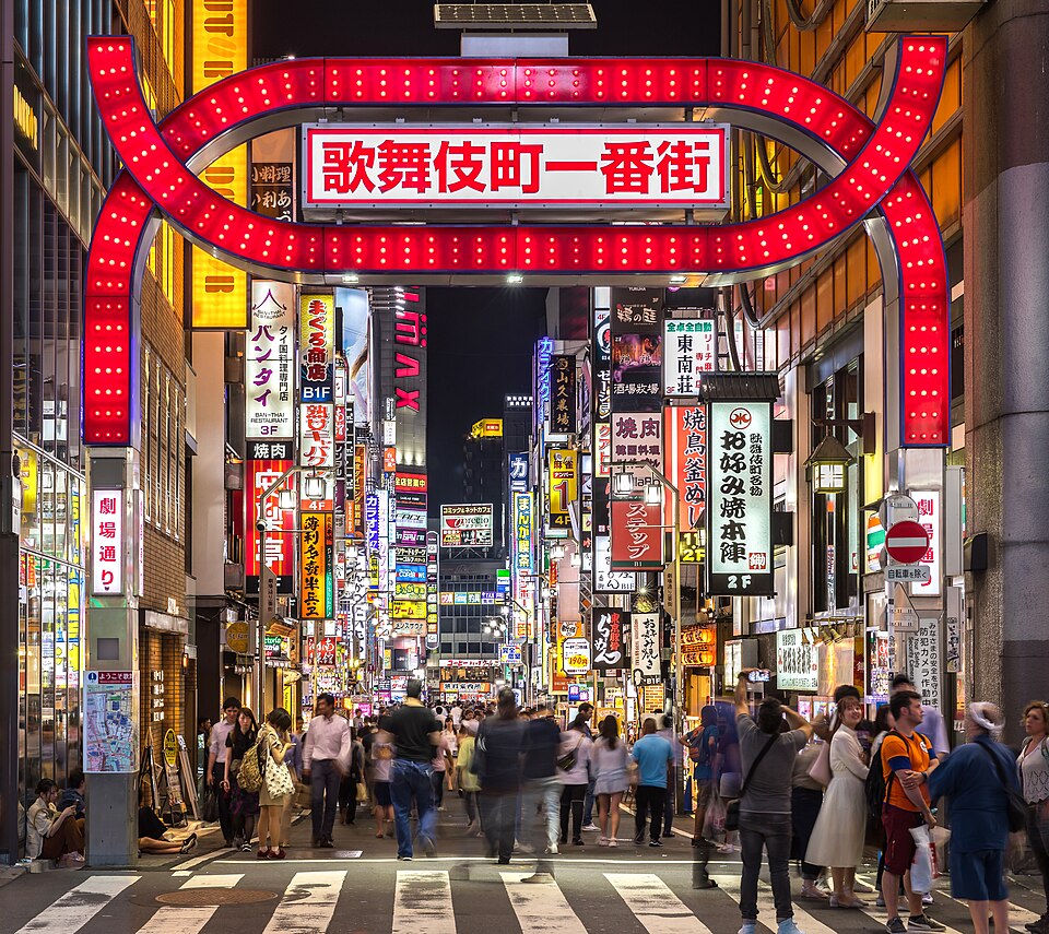 Kabukicho red gate and neon street signs at night in Shinjuku, Tokyo, Japan