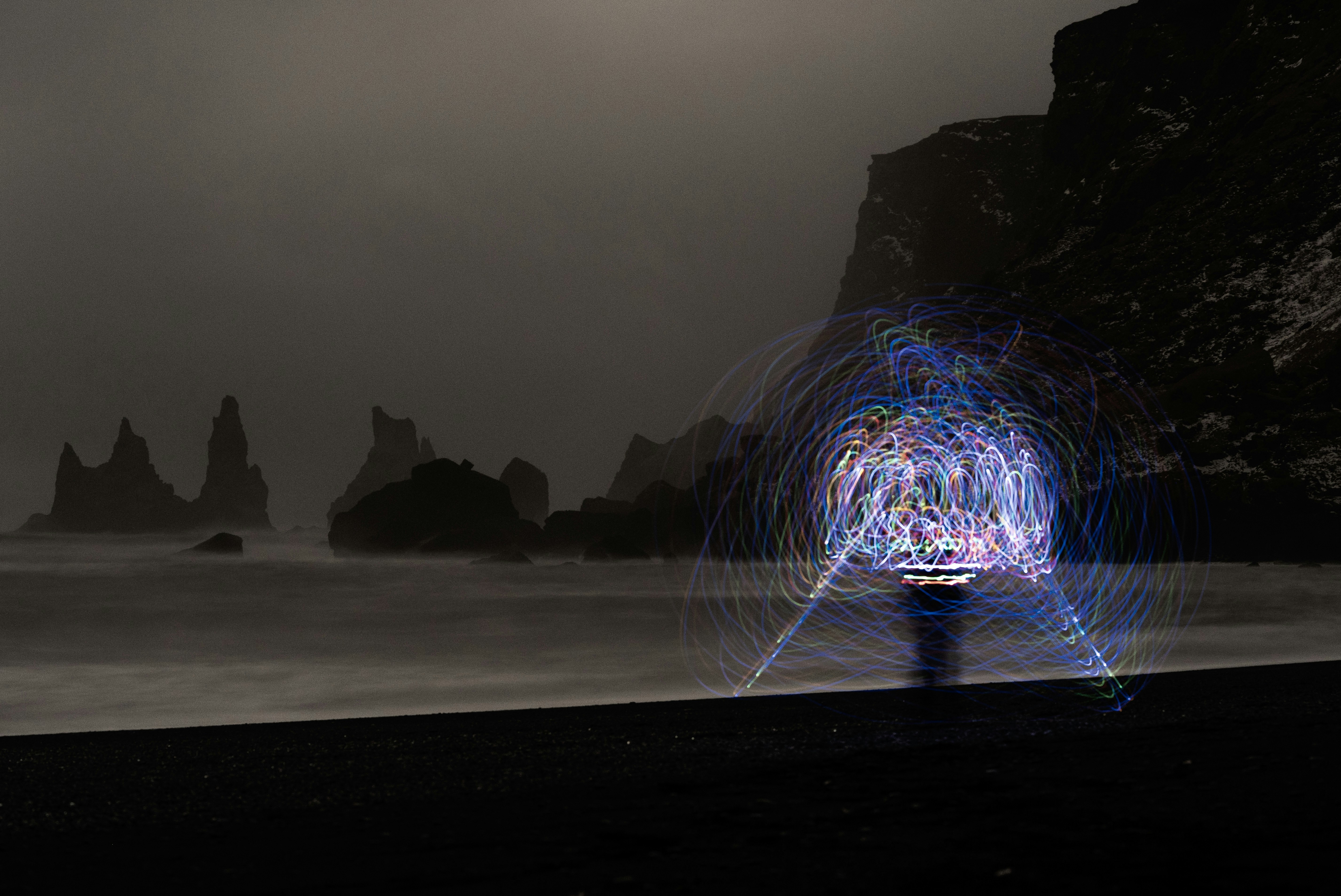 A person standing on a beach looking out at a vast body of water