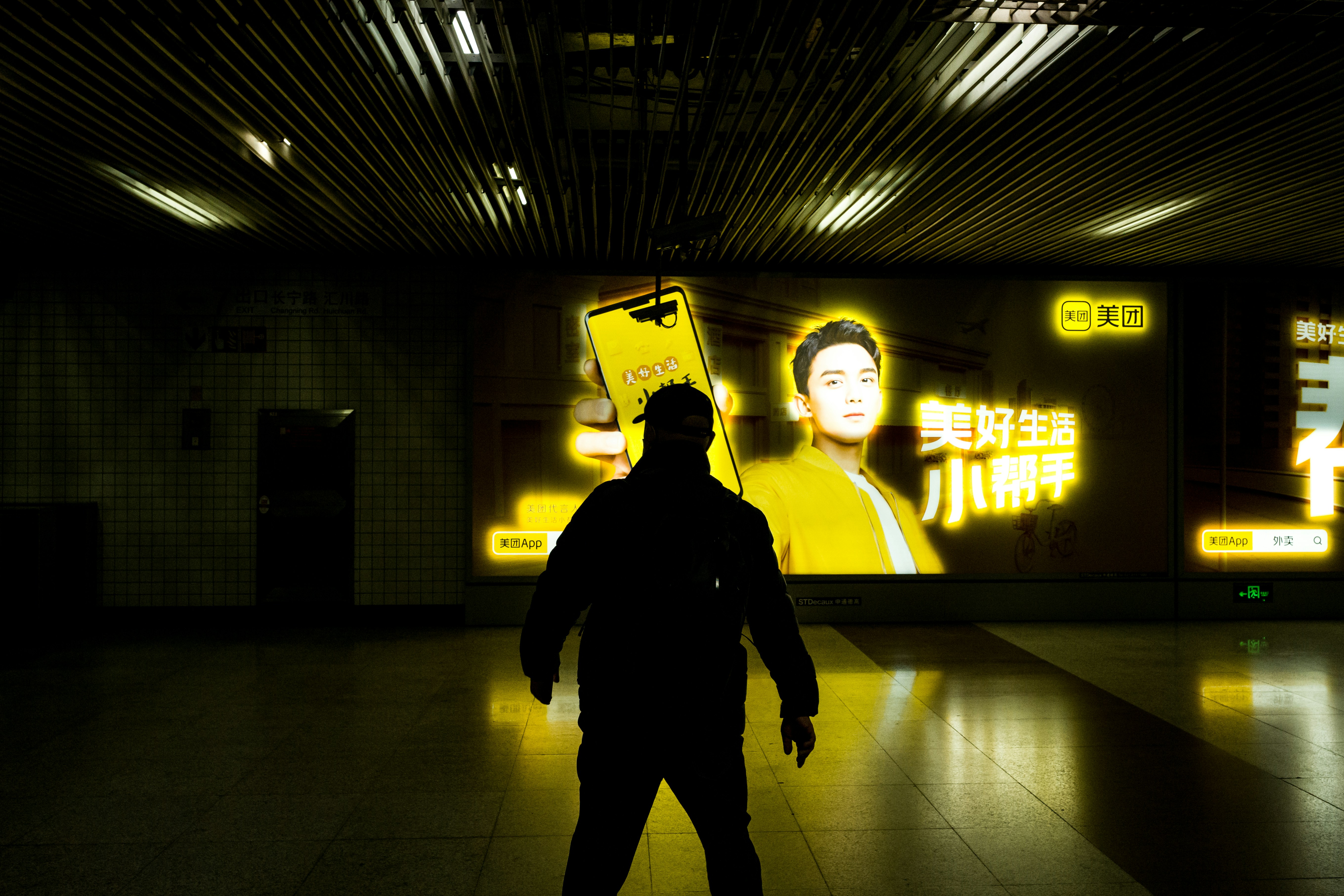 Person standing in front of a large digital screen displaying video content in a studio environment