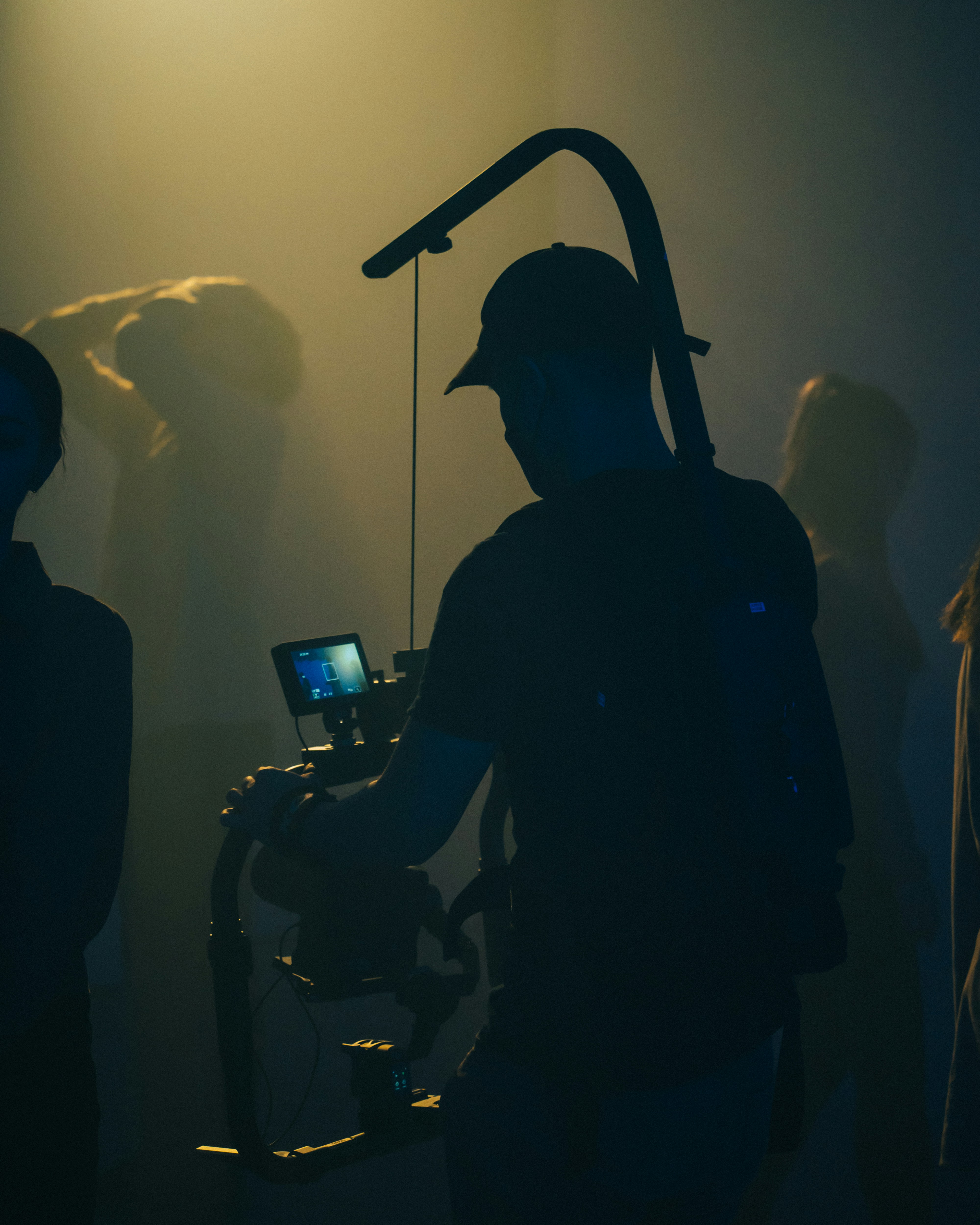 A costumed performer in a mask on a film production set