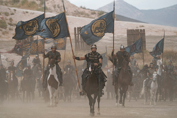 Large-scale battle scene with army on horseback carrying banners