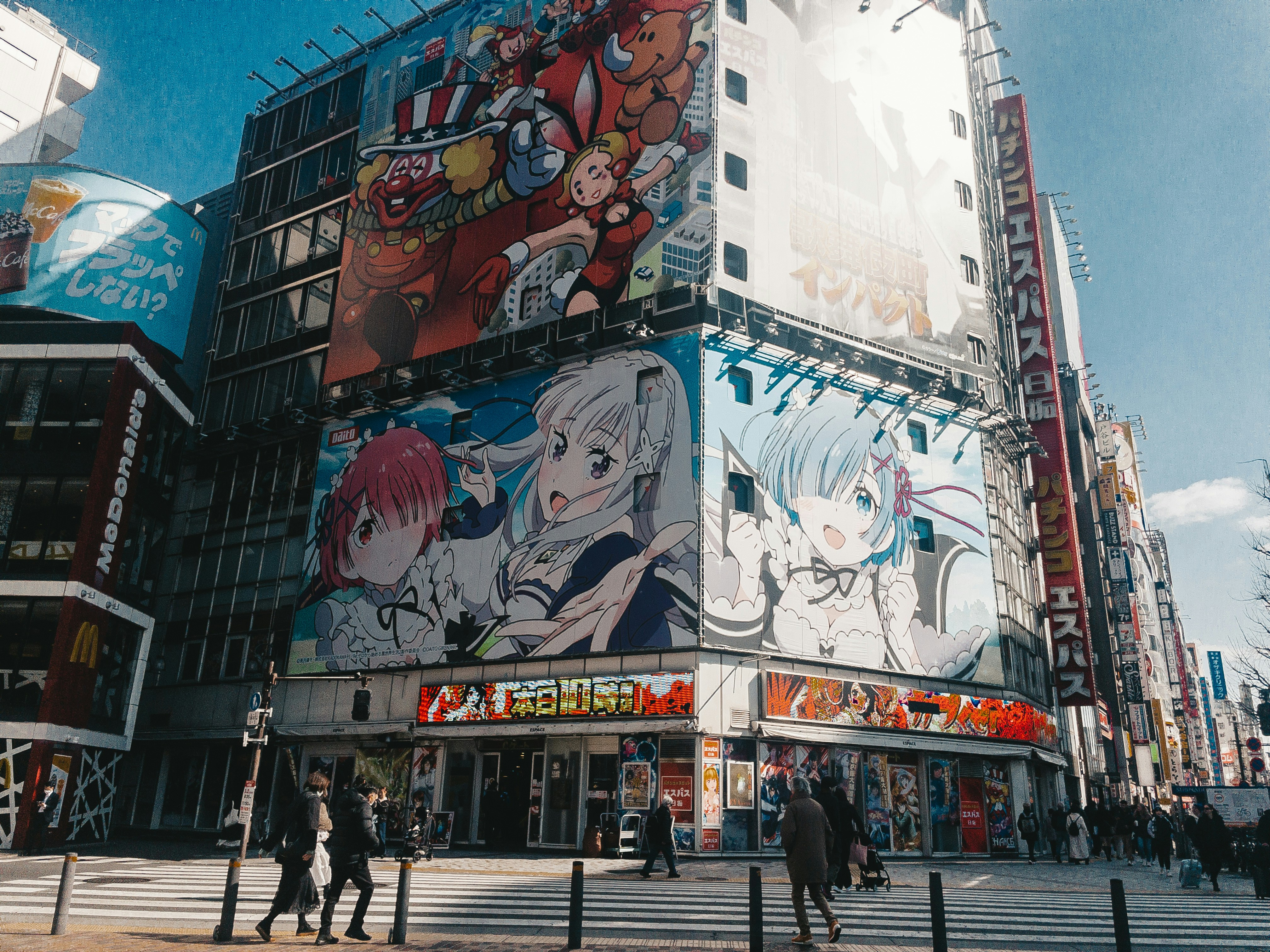 Building facades covered with large anime character billboards in a Japanese city