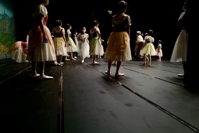 A group of children standing on a stage during a performance or audition