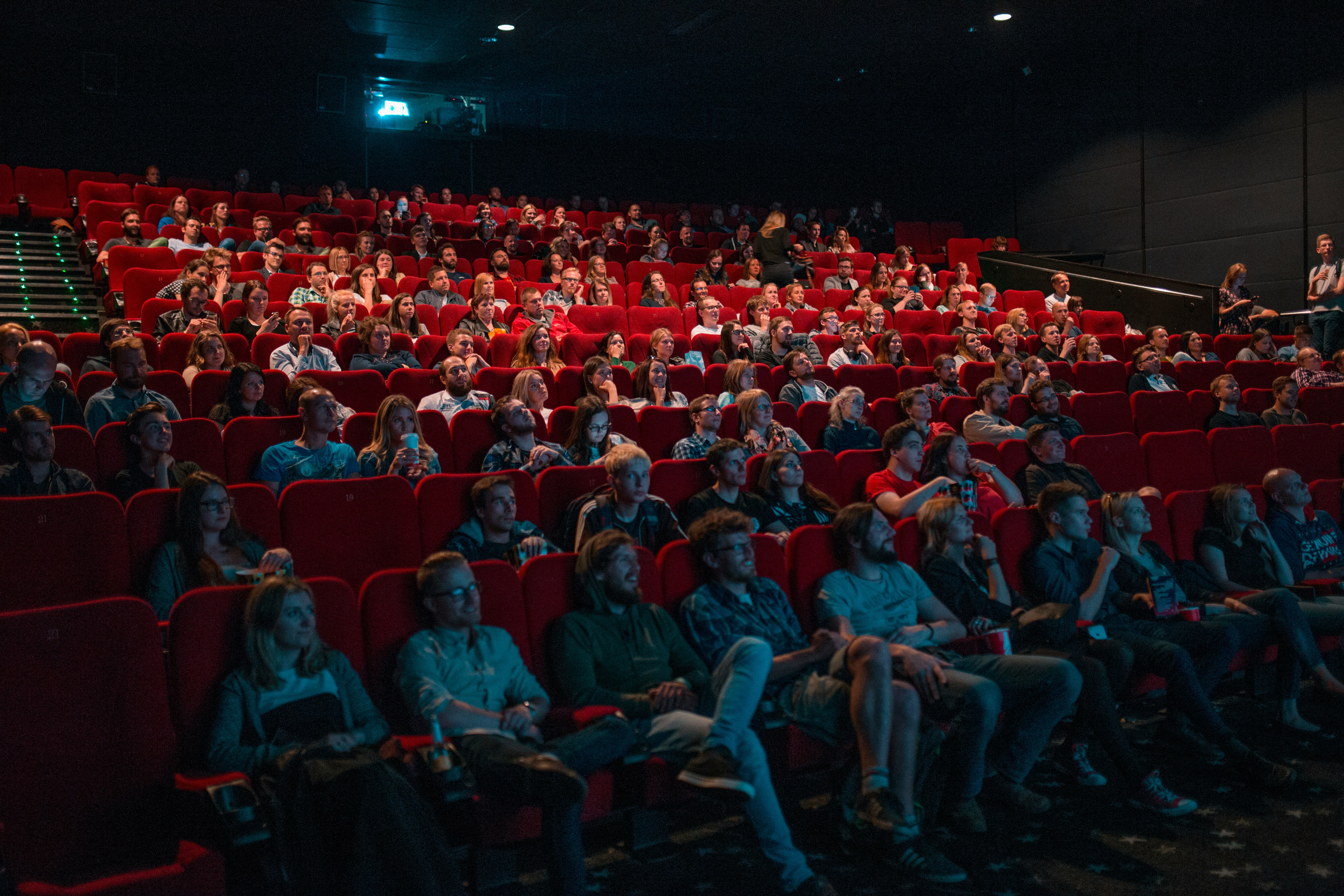 Cinema audience watching immersive theatrical presentation on large screen