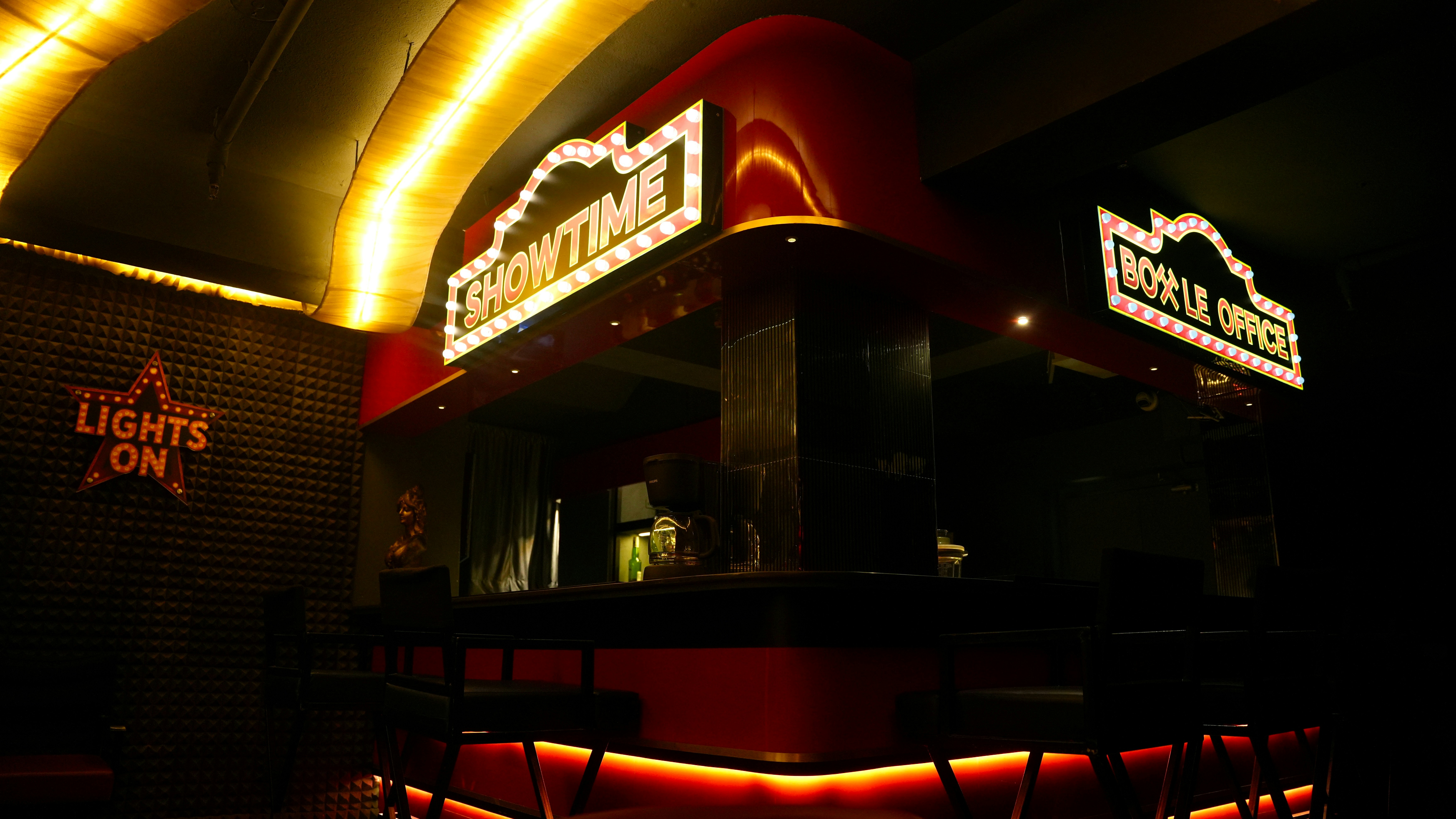 Illuminated Showtime sign glowing behind a darkened cinema bar counter