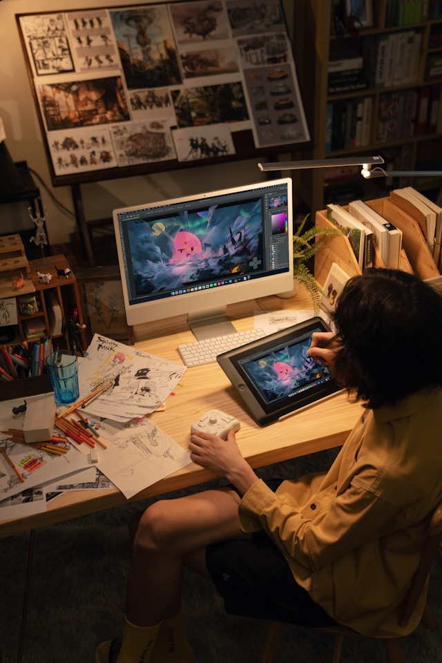 Artist creating digital art on a tablet at a professional desk workstation