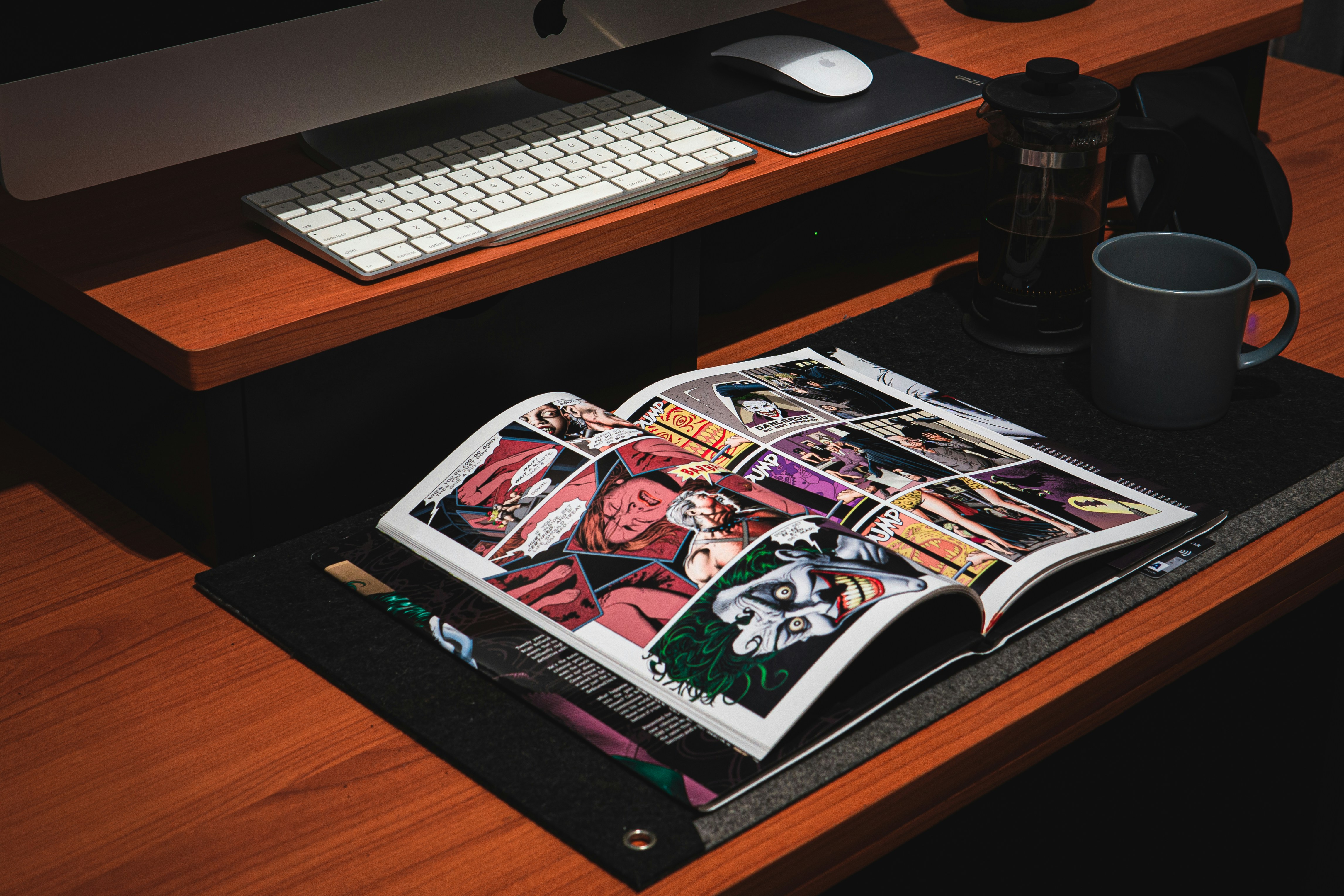 White computer keyboard on a brown wooden desk representing digital animation production workflow